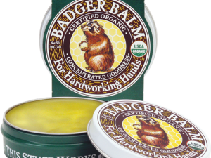 Badger balms default image. A container of badger balms healing hands is open in the foreground with the package sitting behind it.