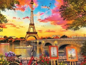 Springbok Puzzles' default image--a very colorful picture of two painting easels portraying the Eiffel Tower, looking across the river at the actual Eiffel Tower. The sky is every color of the rainbow. A bike leans against a stone fence in the foreground.