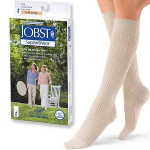Jobst Sosoft compression image. A stocking model wearing white knee-high stockings next to the SoSoft package.