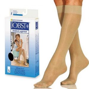 Jobst Ultrasheer default image. A leg model wearing a pair of beige knee high Ultrasheer stockings. Next to the stockings is the Jobst Ultrasheer packaging.