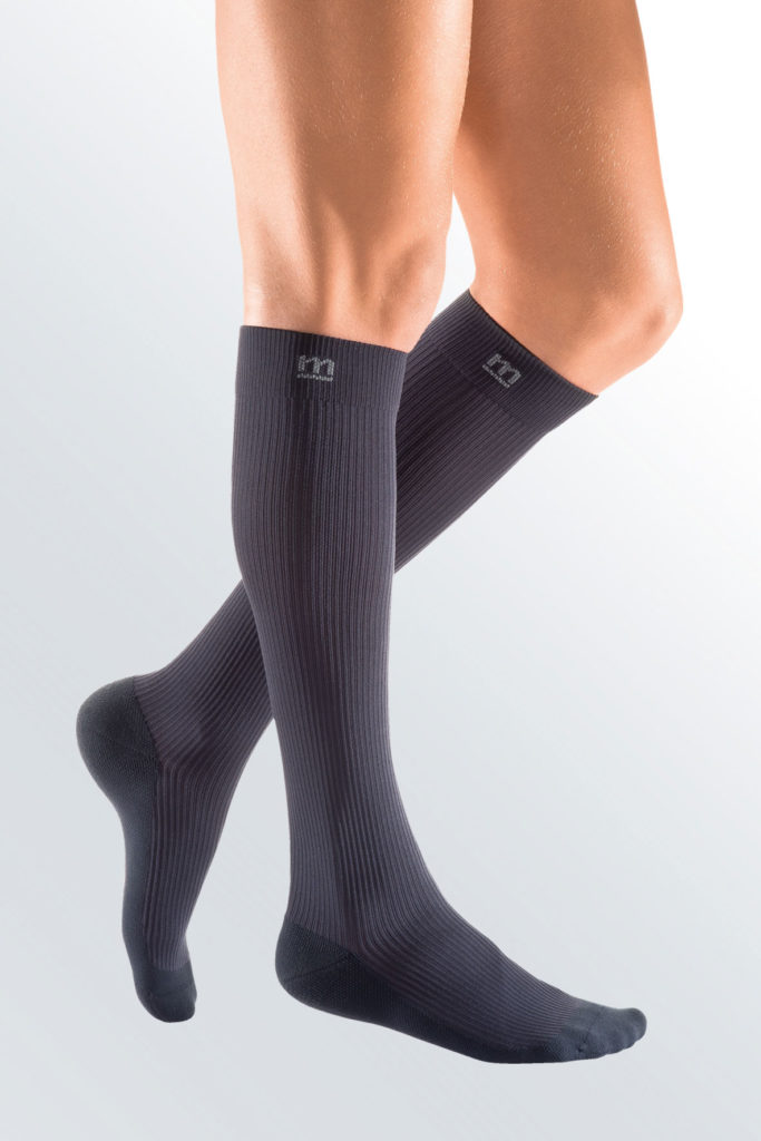 Mediven Active brand default image. A leg model with a pair of dark grey, knee-high compression socks.