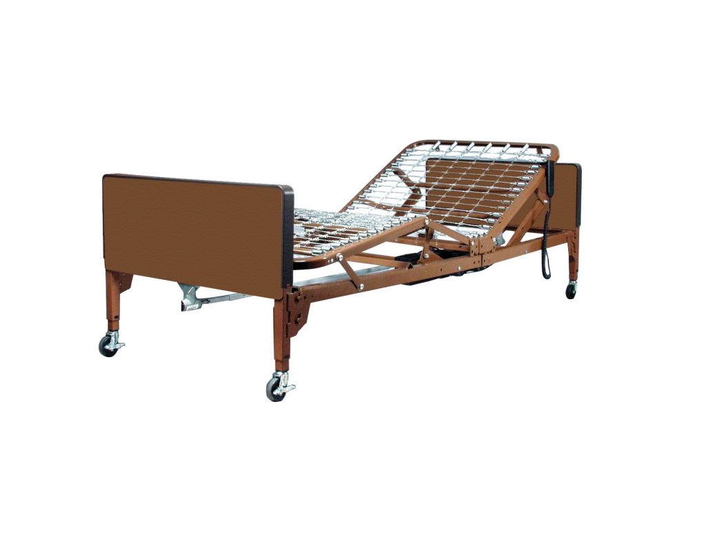 The Probasics Full Electric Hospital Bed Rental, shown in whole. The bed is lowered to it's lowest position, while the mattress "spring board" is in the up position.