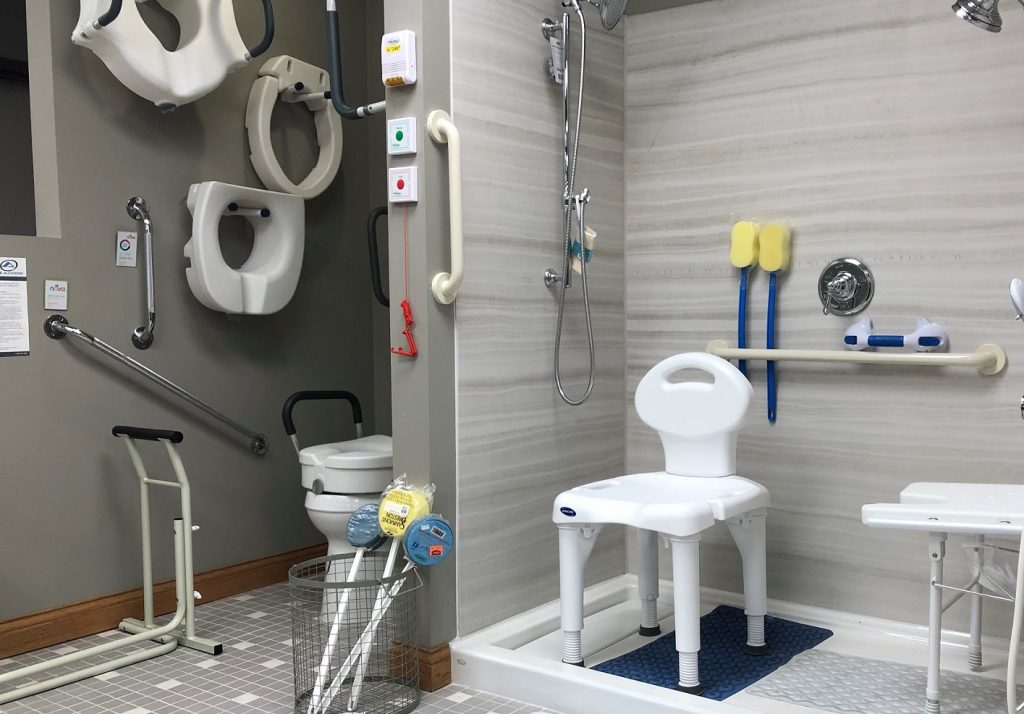 One Stop Post Op Shop Featured Image. A diagonal shot of the Oswald's Medical Equipment Showroom mock bathroom. Many pieces of bathroom safety equipment next to a real toilet and shower. Try before you buy.