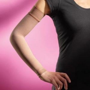 Sigvaris advance armsleeve, worn by a model. The female model is wearing a black shirt, the tan sleeve on her right arm, from the wrist to the shoulder. Pink background.