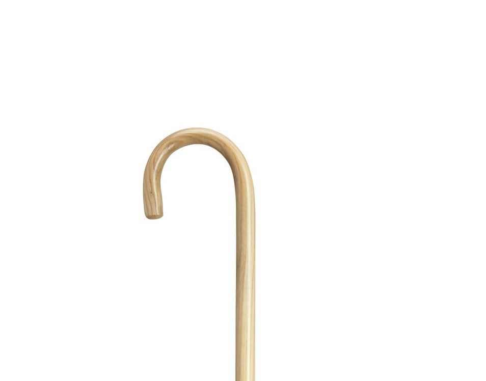 The top half of a Harvy Hospital Cane. Shepherd style curved handle. The entire cane is a very light-tan wood.