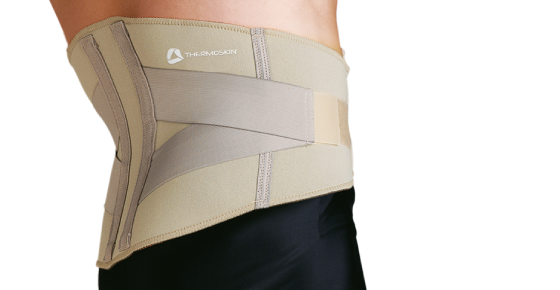 Thermoskin Adjustable Lumbar Support. A model shows off the lumbar support which is tan and has gray criss-crossing, adjustable straps.