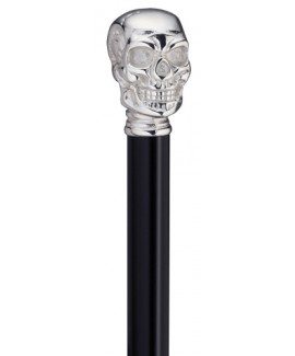 The top half of a Harvy The Skull Cane. A silver skull rests on a black cane shaft.