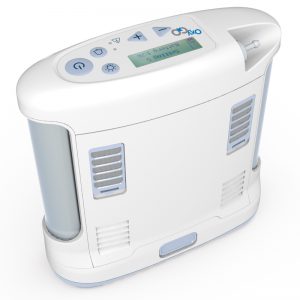 OxyGo Portable Oxygen Concentrator image. The oxygo is shown up close on a white background. The unit is not plugged in.