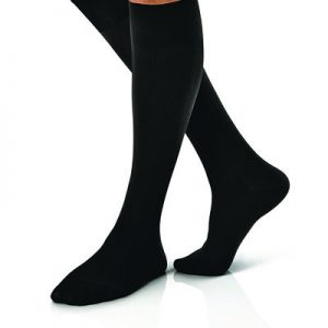 Jobst For Men Compression Socks in black on a leg model. Knee high casual business style in black.