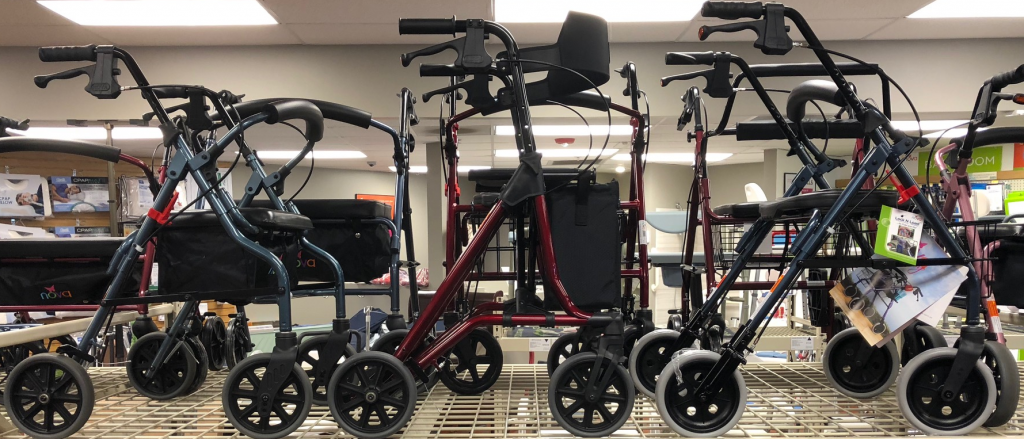 Picture of Oswald's in-store, showcasing 3 different rollator models on a large rack with dozens more rollators.