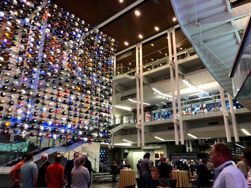 Picture of the entrance to the College Football Hall of Fame during Medtrade 2018. Hundreds of football helmets from US colleges can be seen.