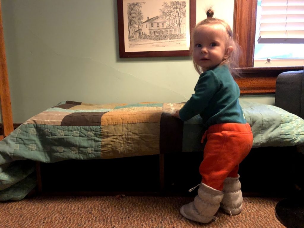 The youngest Oswald's family member, baby Arlo, standing up with a pair of Vivi G'z. Demonstrating even the most active babies can't loose these booties.