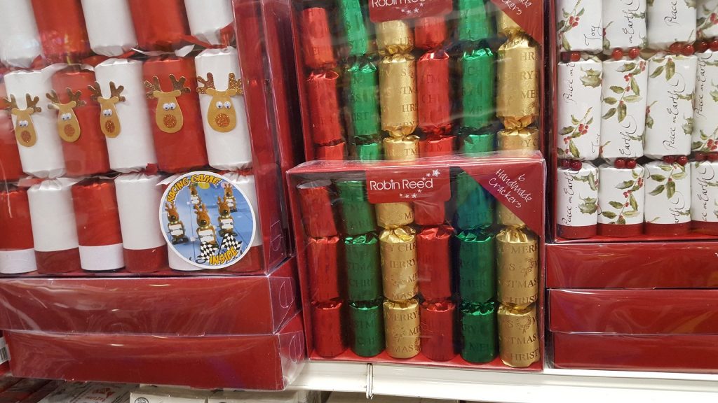 Robin Reed Party Crackers on the shelves in Oswald's Christmas section. Each box contains a different amount of various sizes of Christmas party crackers. There is a secret prize inside each one.