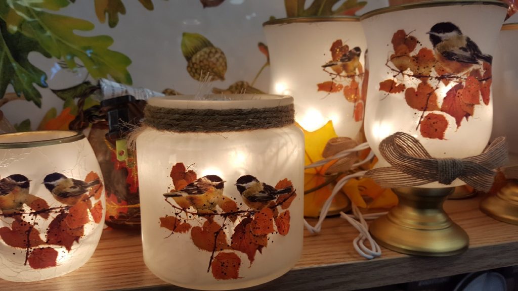 Stony Creek Lite Vases. Closeup image of 3 fall themed vases. These etched glass vases are hand painted with seasonal images and have a light inside that creates some beautiful illumination.