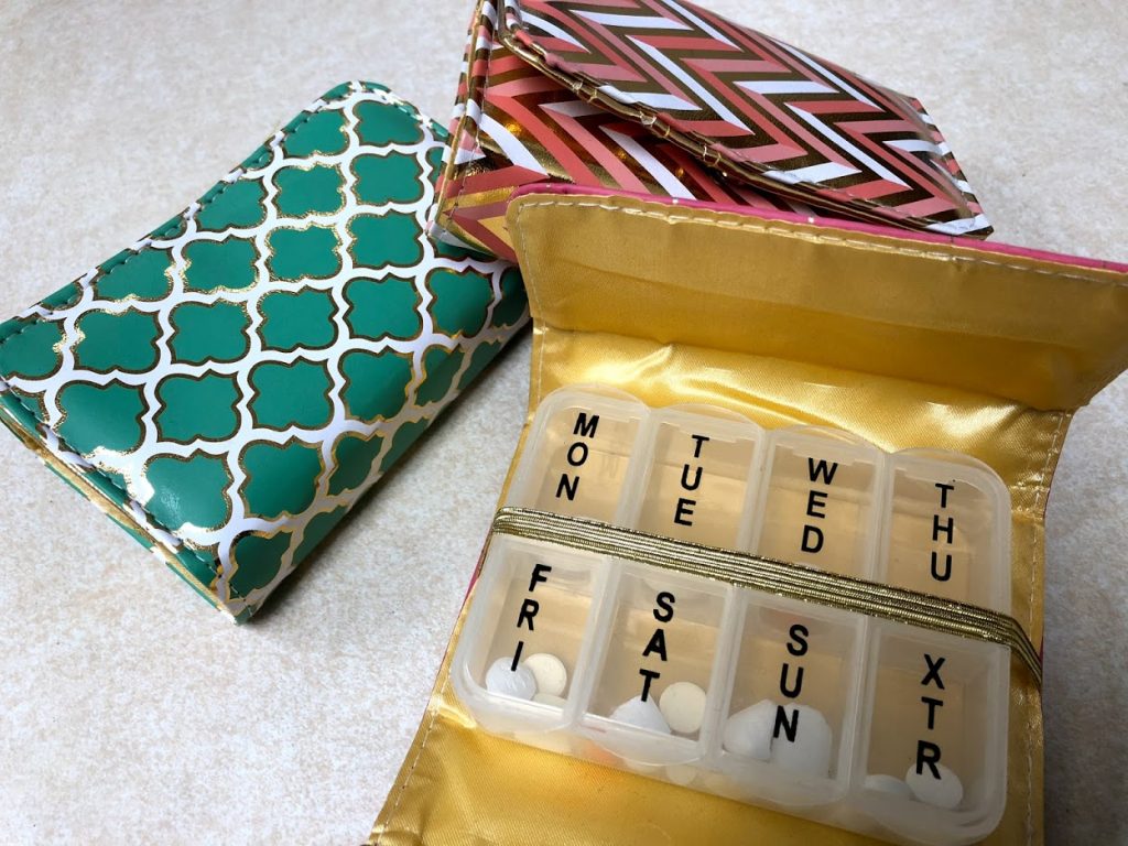 3 decorative pill boxes on the counter at Oswald's Pharmacy. There are many styles available--your pillbox can match your personality!