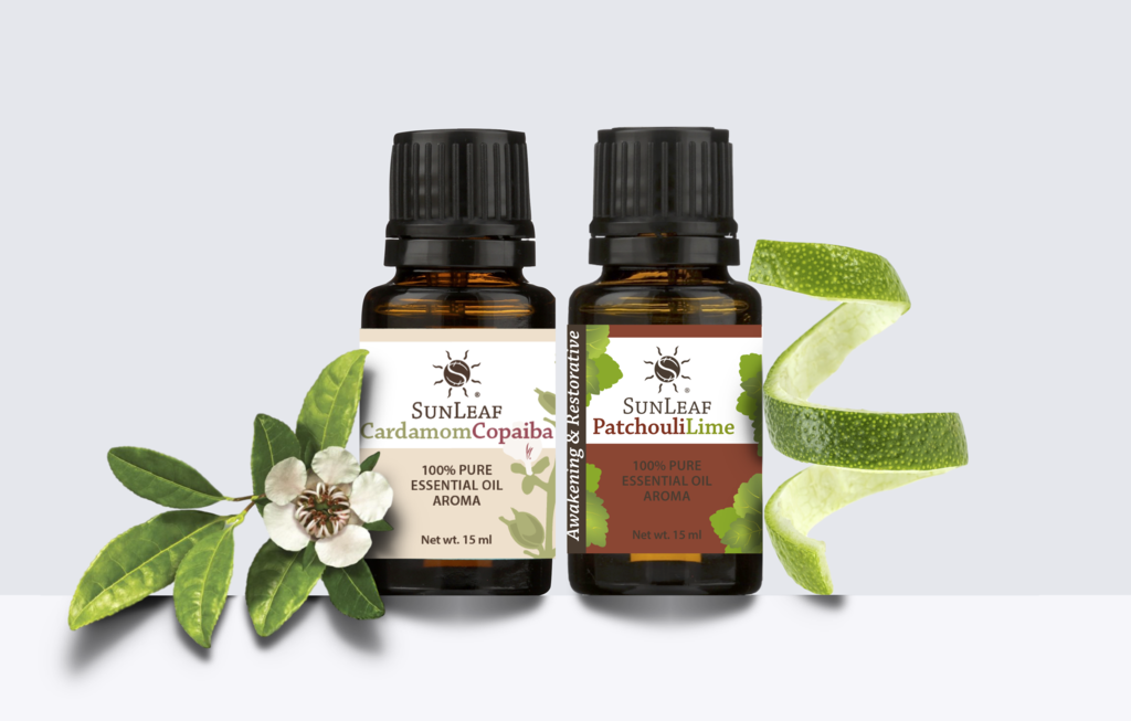 Sunleaf Naturals Organic Cleaning Blog Featured image. Two bottles of Sunleaf Naturals essential oils with some flowers and lime rinds in the background.