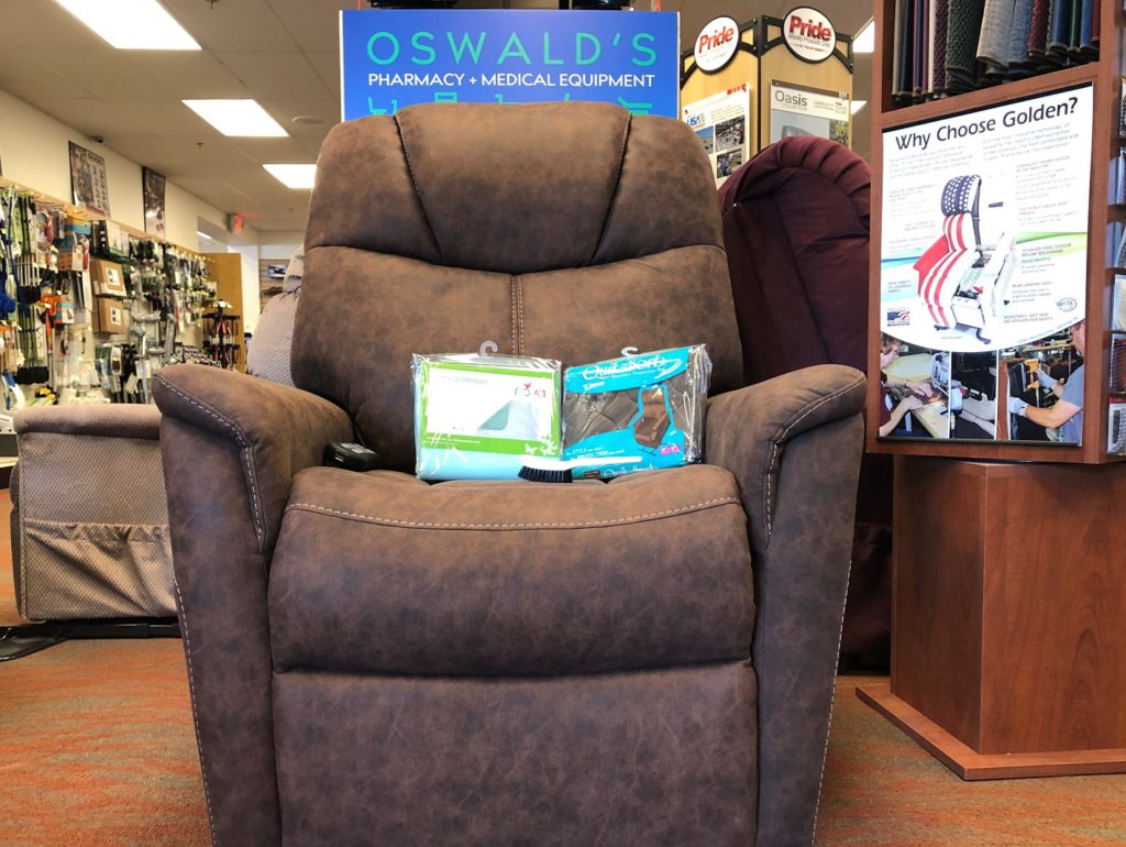 How to Take Care of Your Lift Chair inset image. A Golden Siesta lift chair on the Oswald's Medical Equipment Showroom floor. A cleaning brush and two brands of chair underpads rest on the chairs seat.