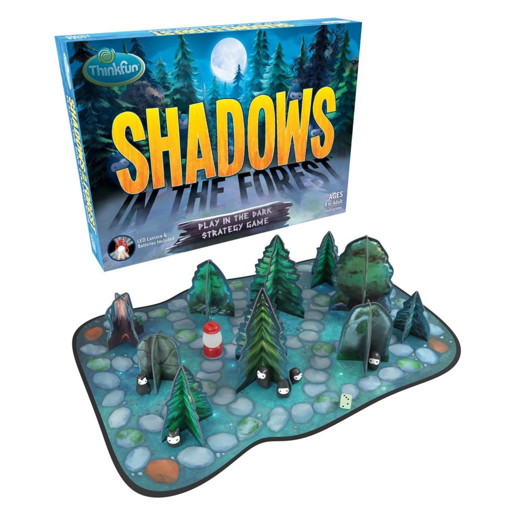 Shadows in the Forest Board Game. Image shows the board game packaging over the board with tree and rock game pieces.