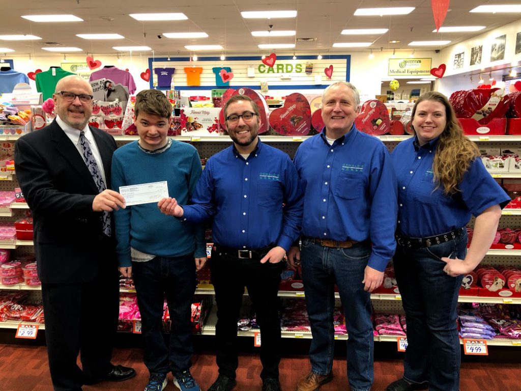 The managers of Oswald's Pharmacy presenting Little Friends Inc. with a $2,000 donation check from funds raised in 2019.