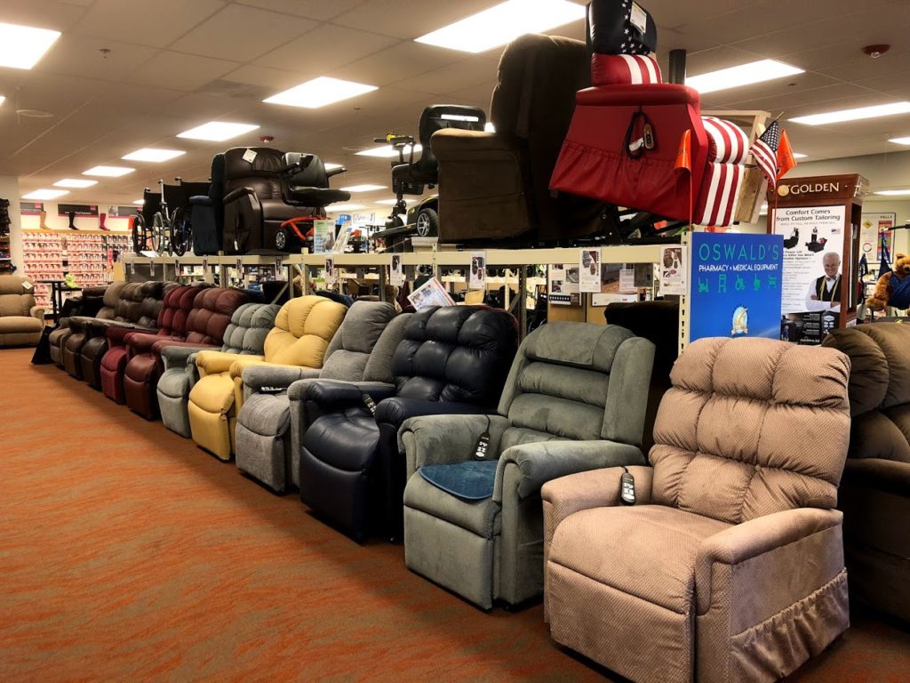 A photo of some of the lift chairs available at Oswald's Pharmacy. A row of chairs is pictured, all manufactured by Golden Technologies and Pride Mobility.