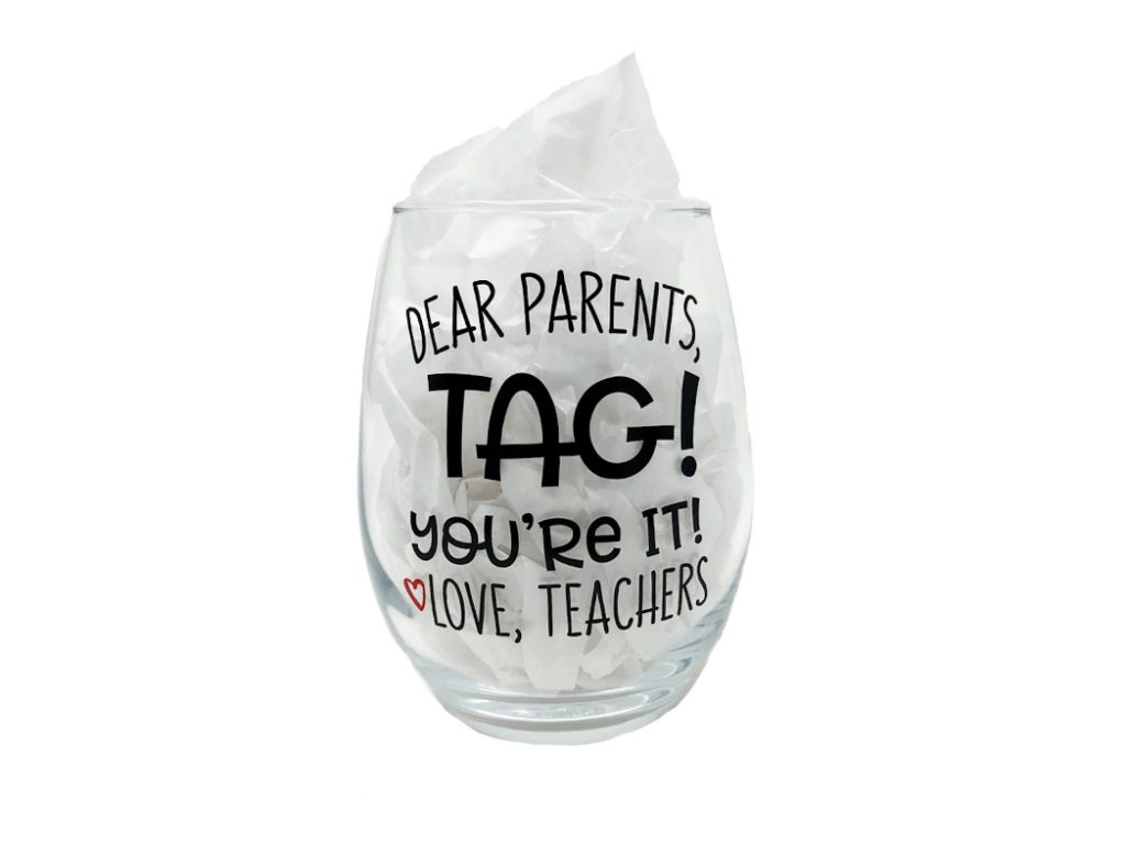 Dear Parents, TAG! You're It Love, Teachers 12oz Glass. A clear, stemless wine glass with the name printed on it.