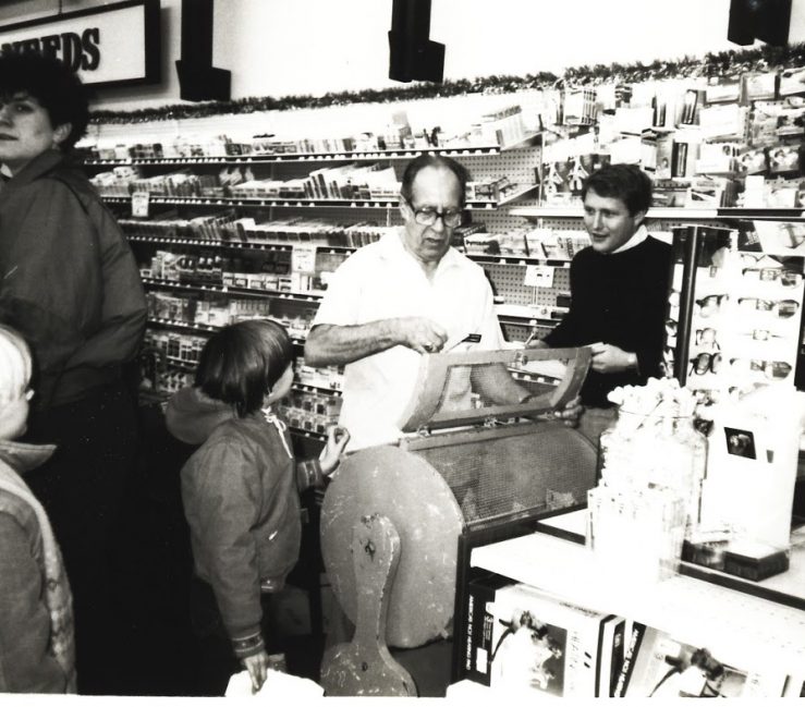 A photograph of a raffle behind held in Oswald's in 1980. 3rd generation owner Harold Kester is drawing the winning ticket while standing next to his grandson (and 5th generation owner) Bill Anderson.