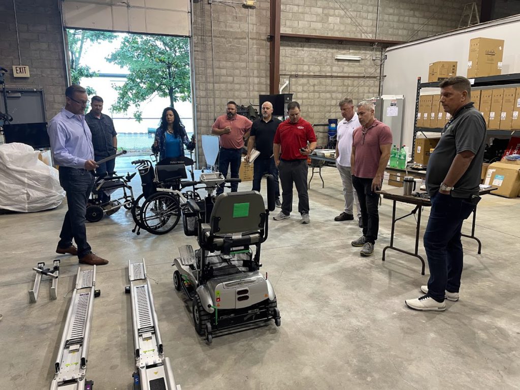 Message from Alex May 2022 featured image. Photo of the Independent Medical Retailers Group viewing a mobility scooter speed test.