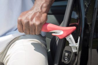 Stander Handybar Auto Grab Bar. Photo of the grab bar being used on a car door.
