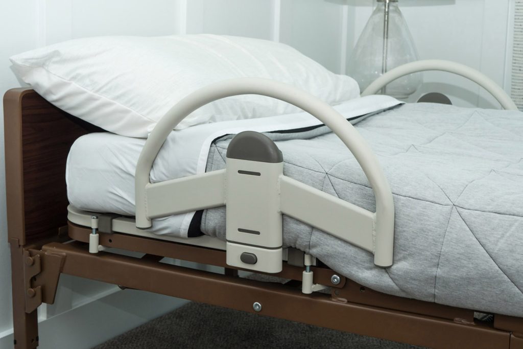 Stander EZ Click LTC Bed Handle. Phot of the bed rail attached to a bed.
