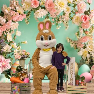 Oswald's Easter Photo Event 2024. Photo of a girl sitting next to the Easter bunny.