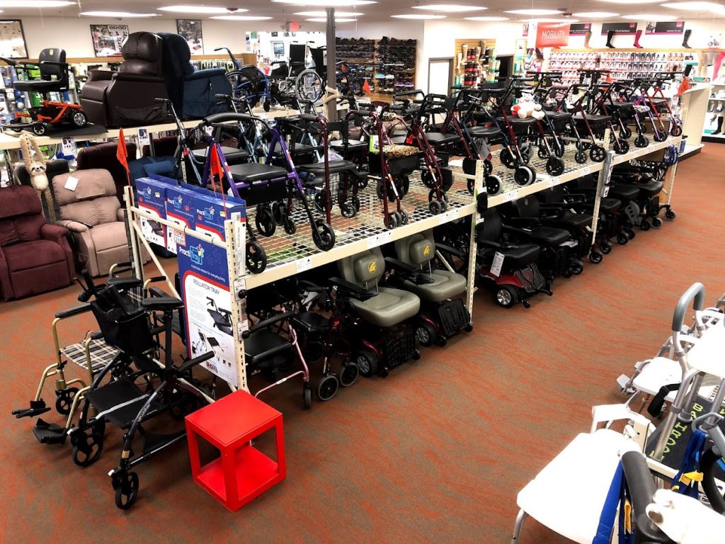 A variety of rollators, transport chairs, scooters, and power chairs neatly displayed in the Oswald’s Medical Equipment Showroom.