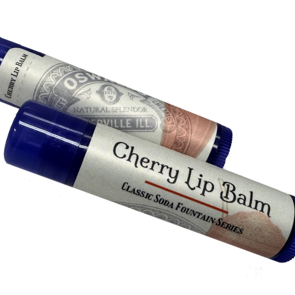 Two tubes of Oswald’s Cherry Lip Balm from the Classic Soda Fountain Series, featuring vintage-style labels and blue caps.