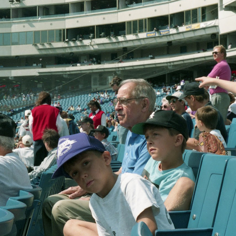 Two young boys and their grandfather sit in the stands at a Chicago White Sox game in the 1990s.
